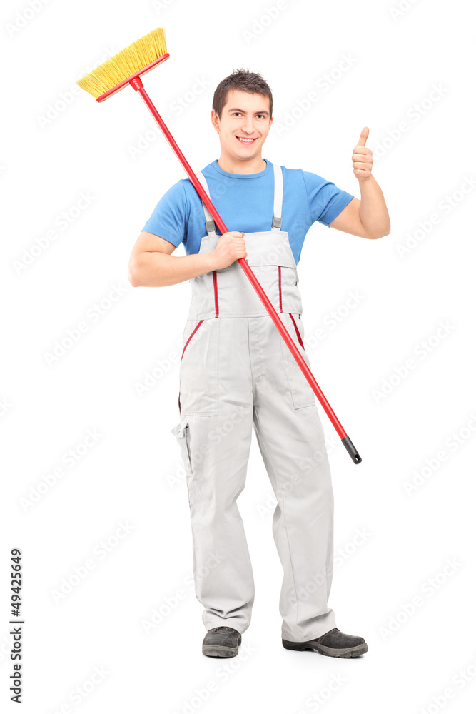 Full length portrait of a male cleaner with brush and a thumb up