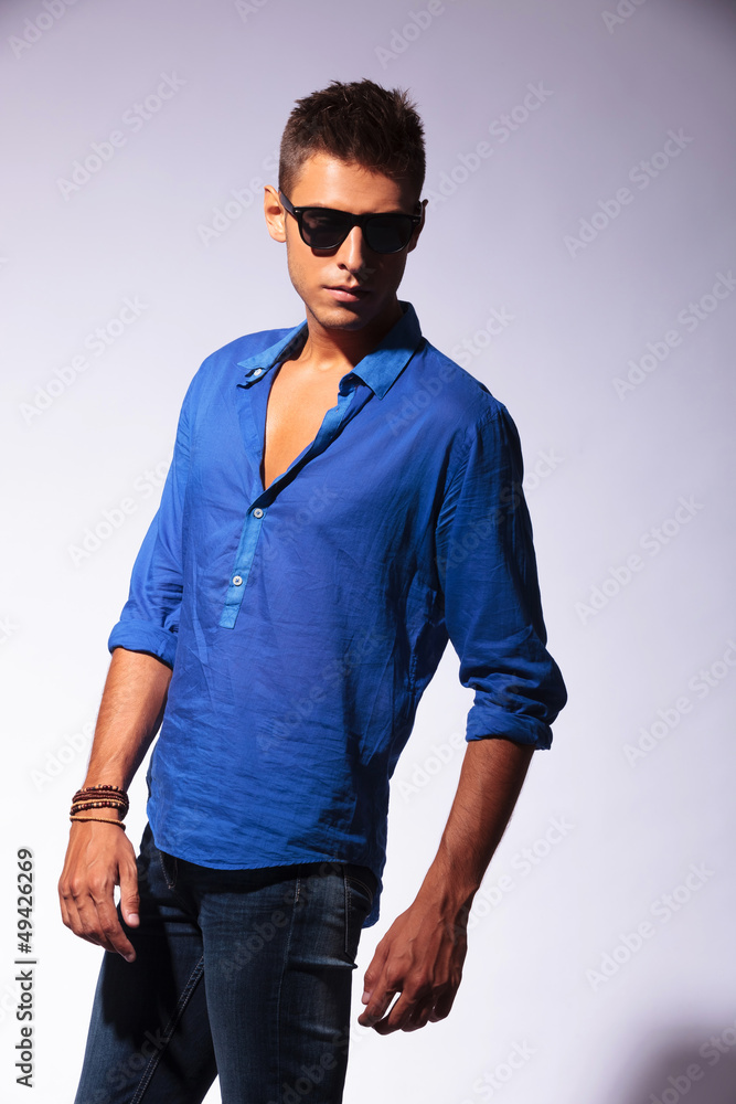 casual man posing with sunglasses casual man posing with sunglasses