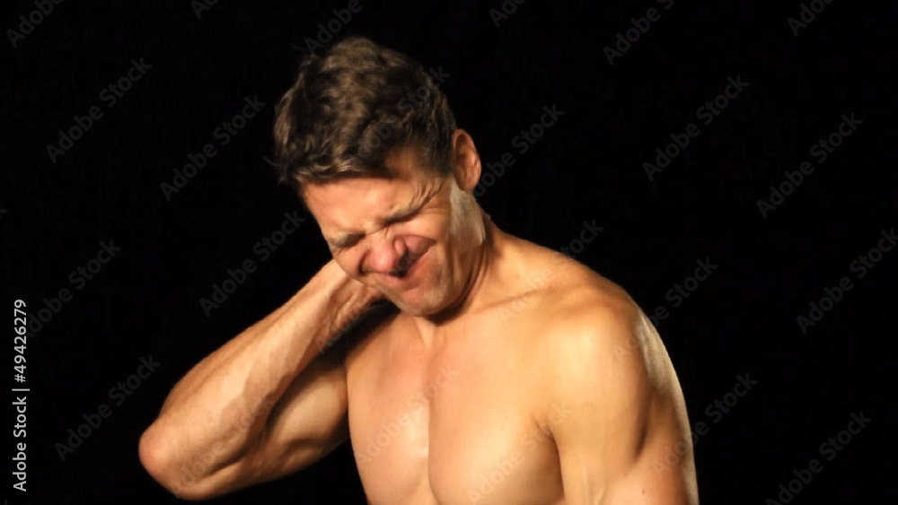 Athletic shirtless man suffers with neck pain Athletic shirtless man suffers with neck pain