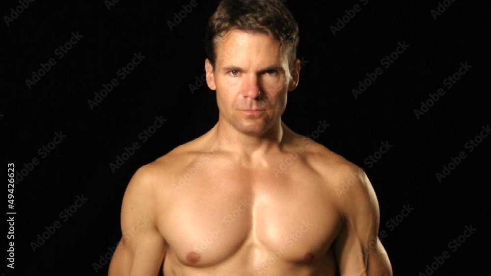 Muscular man flexes and bounces pectoral muscles Muscular man flexes and bounces pectoral muscles