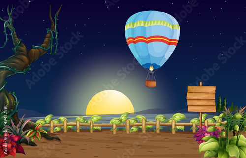 A hot air balloon in a bright full moon