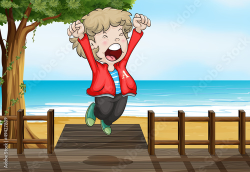A boy jumping happily in the bridge