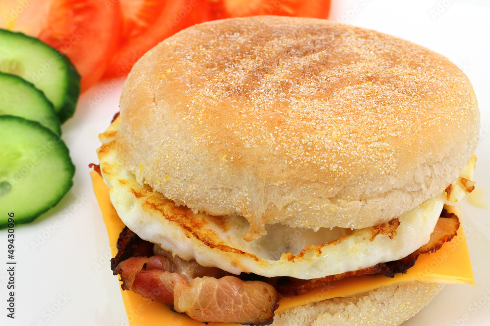 English muffin with bacon and egg and Cheddar cheese English muffin with bacon and egg and Cheddar cheese