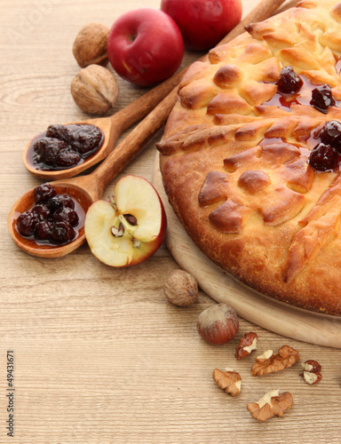 tasty homemade pie with jam and apples  on wooden table