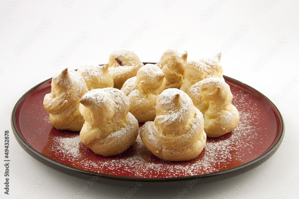 sweet profiteroles with powdered sugar
