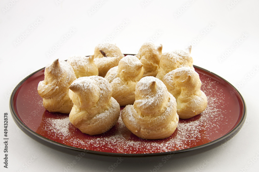 sweet profiteroles with powdered sugar sweet profiteroles with powdered sugar