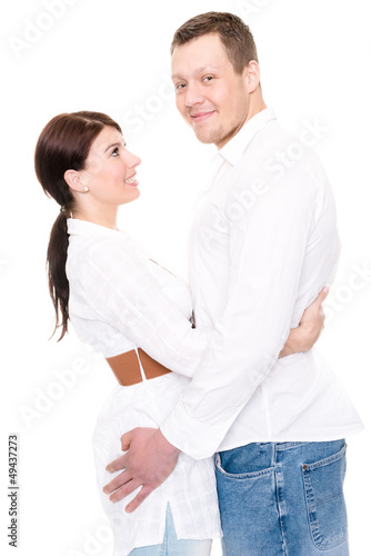 Young and happy couple in front of white background