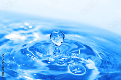 Splash of water on blue surface