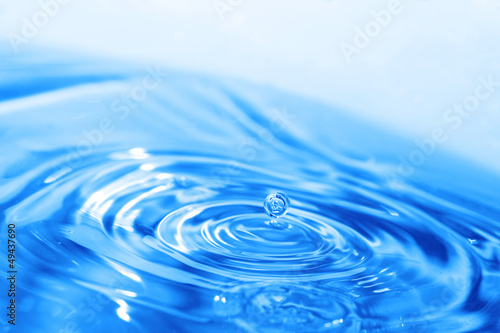 Splash of water on blue surface