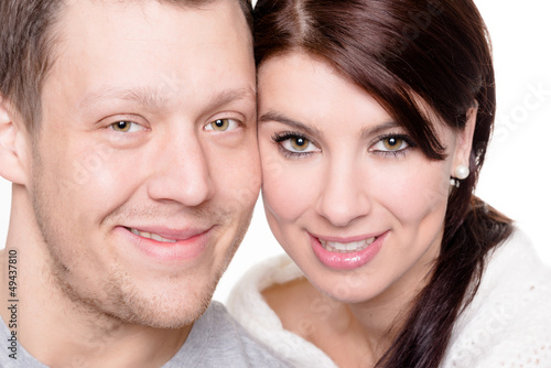 Young and happy couple in front of white background