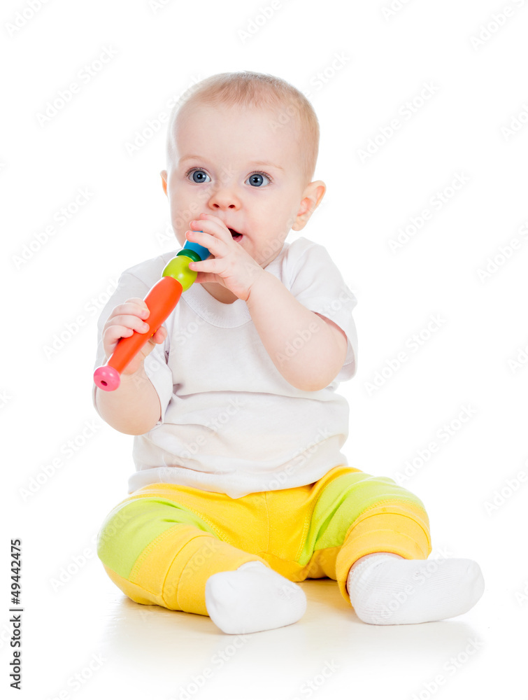Funny baby girl playing with musical toy. Isolated on white bac Funny baby girl playing with musical toy. Isolated on white bac
