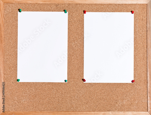 white sheets of paper on cork board
