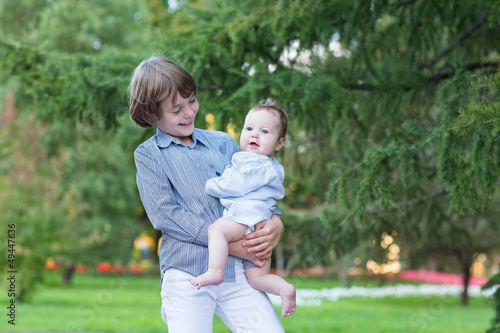 Happy laughing kids, brother and sister in a park