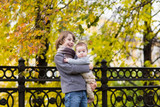 Boy and sister walking in an autumn park