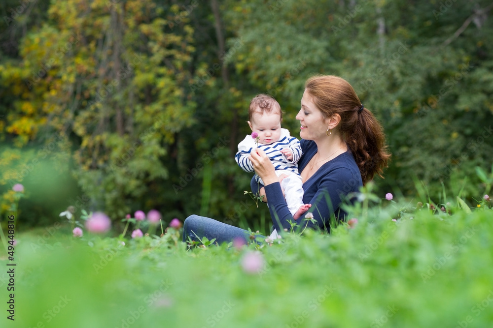 Mother showing baby clover flower summer day Mother showing baby clover flower summer day