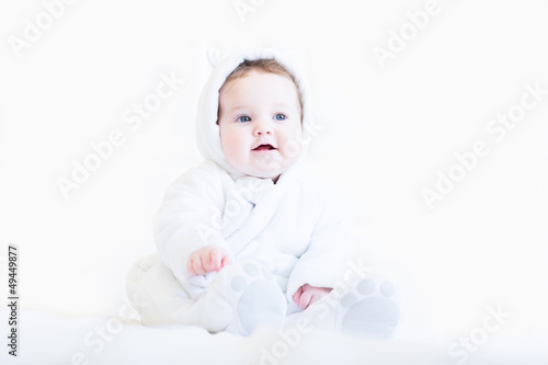 Sweet baby in a white teddy bear snow suit