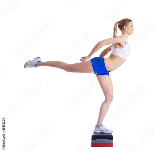 Young fitness woman on stepper