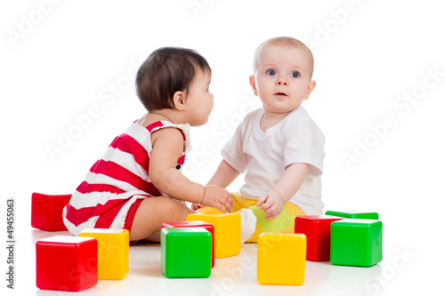 two babies girls playing to...
