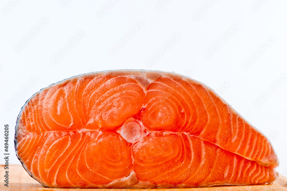 Red is a piece of salmon on a white background
