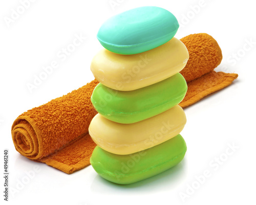 Towel and Stack of new colorful Soap Bars on white background.