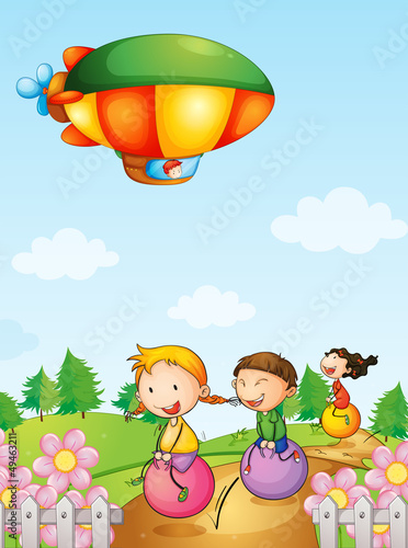 Three kids playing below an airship