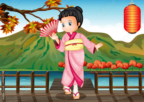 A girl in a kimono attire at the bridge