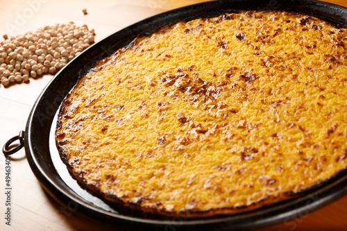 Typical Italian Pizza, ingredients in background on wood table