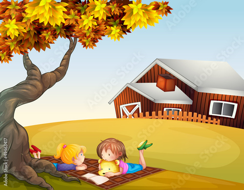 Kids reading under a big tree