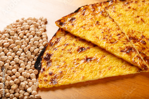 Typical Italian Pizza with ingredients in the background on a wo