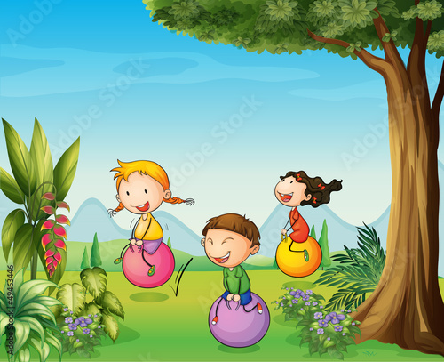 Three kids having fun with a bouncing ball