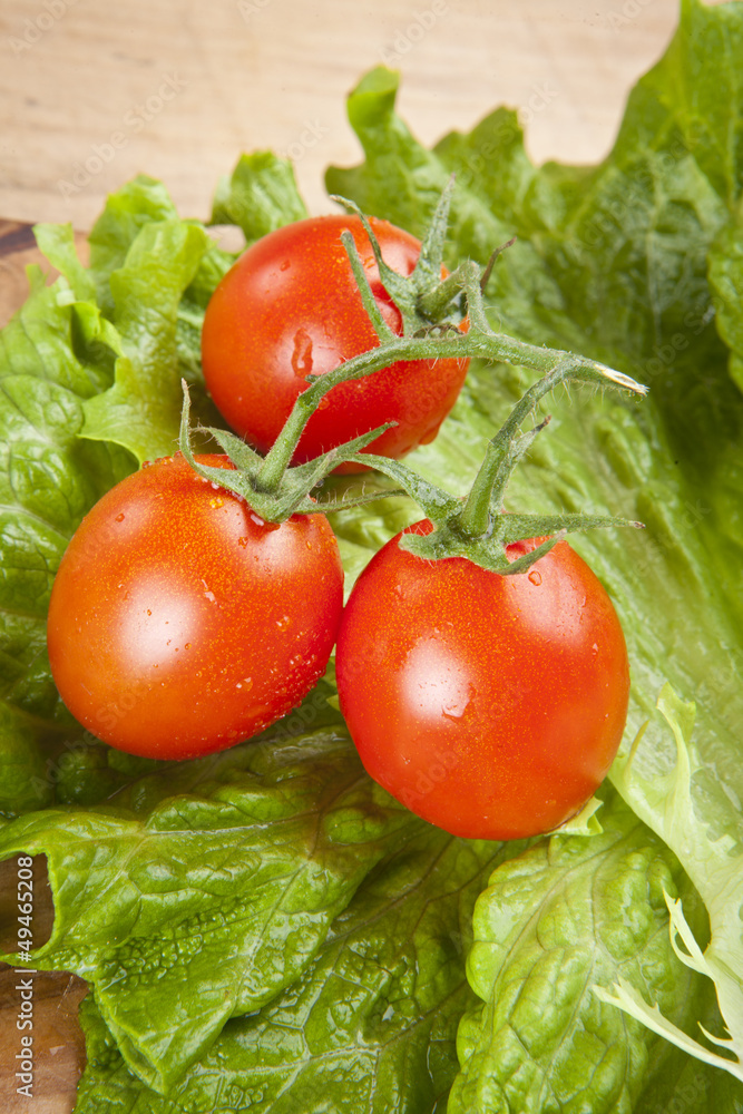 fresh ripe cherry tomato and lettuce on wooden table fresh ripe cherry tomato and lettuce on wooden table
