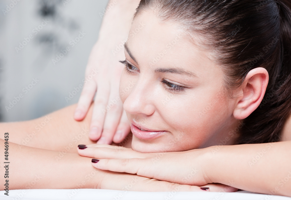 Smiling female during luxurious procedure of massage Smiling female during luxurious procedure of massage
