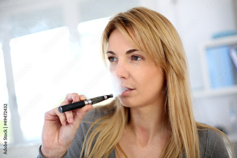 Woman smoking with electronic cigarette Woman smoking with electronic cigarette