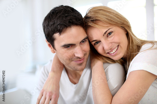 Couple embracing each other on sofa