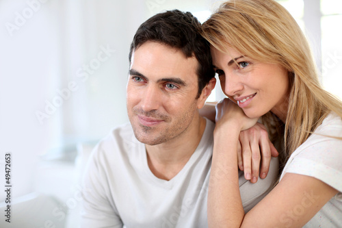 Couple embracing each other on sofa