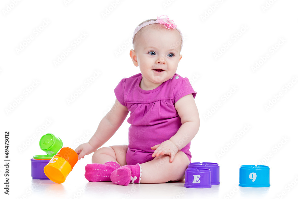 Funny baby girl playing with cup toys, isolated over white Funny baby girl playing with cup toys, isolated over white