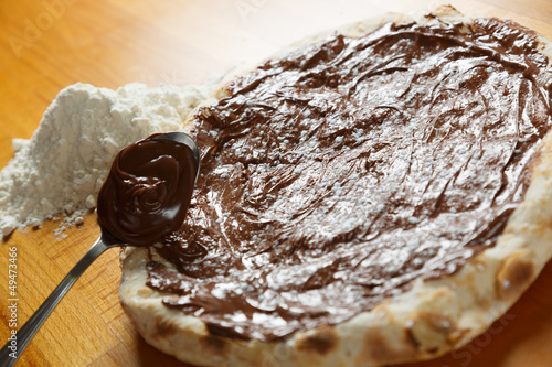 Typical Italian Pizza, ingredients in background on wood table