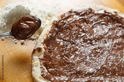 Italian Pizza, ingredients in the background on a wood table