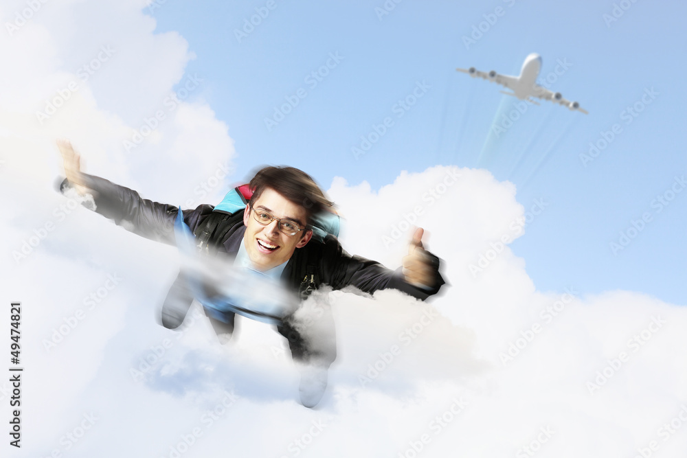 Young businessman flying with parachute on back Young businessman flying with parachute on back