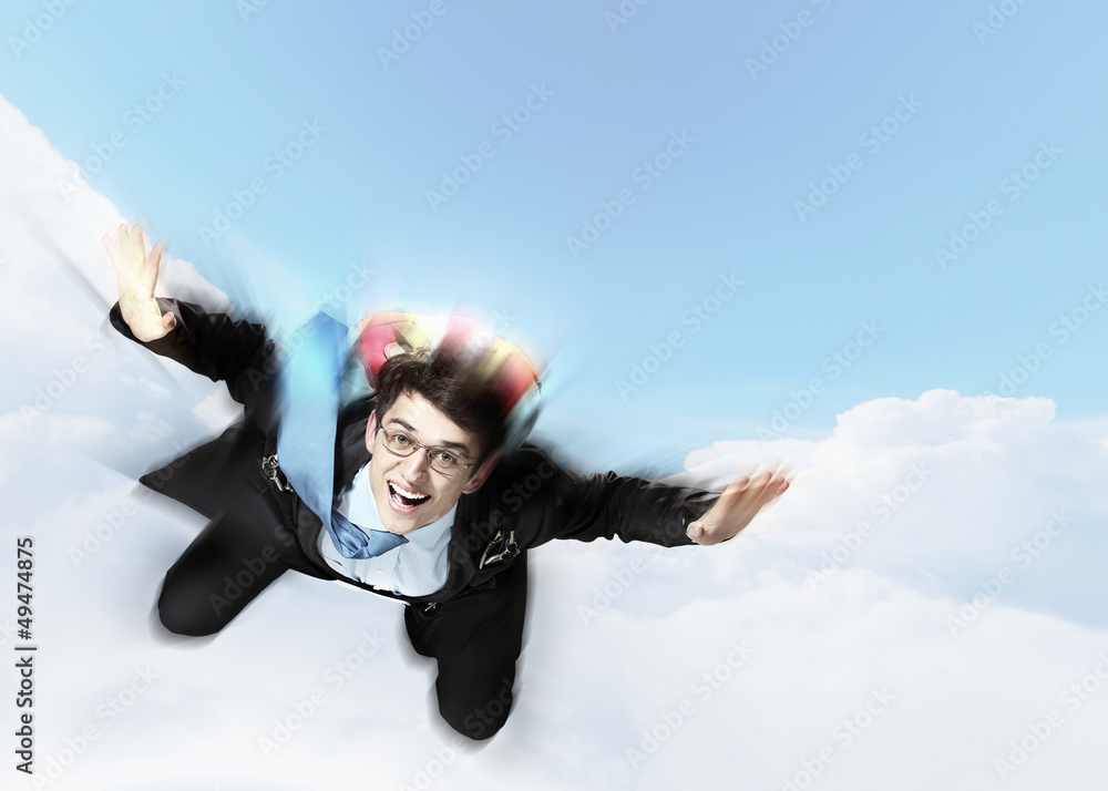 Young businessman flying with parachute on back Young businessman flying with parachute on back