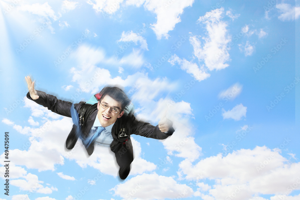 Young businessman flying with parachute on back Young businessman flying with parachute on back