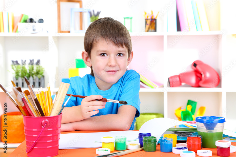 Cute little boy painting in his album Cute little boy painting in his album