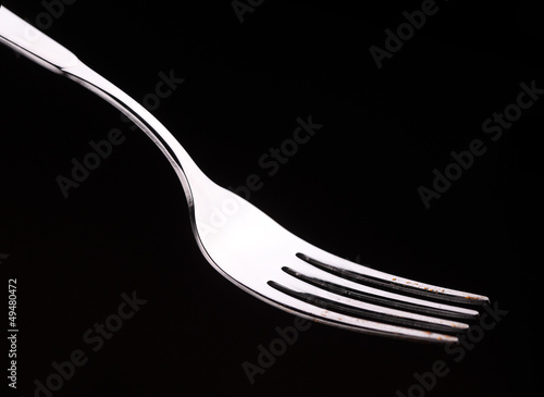 Empty fork on a black background