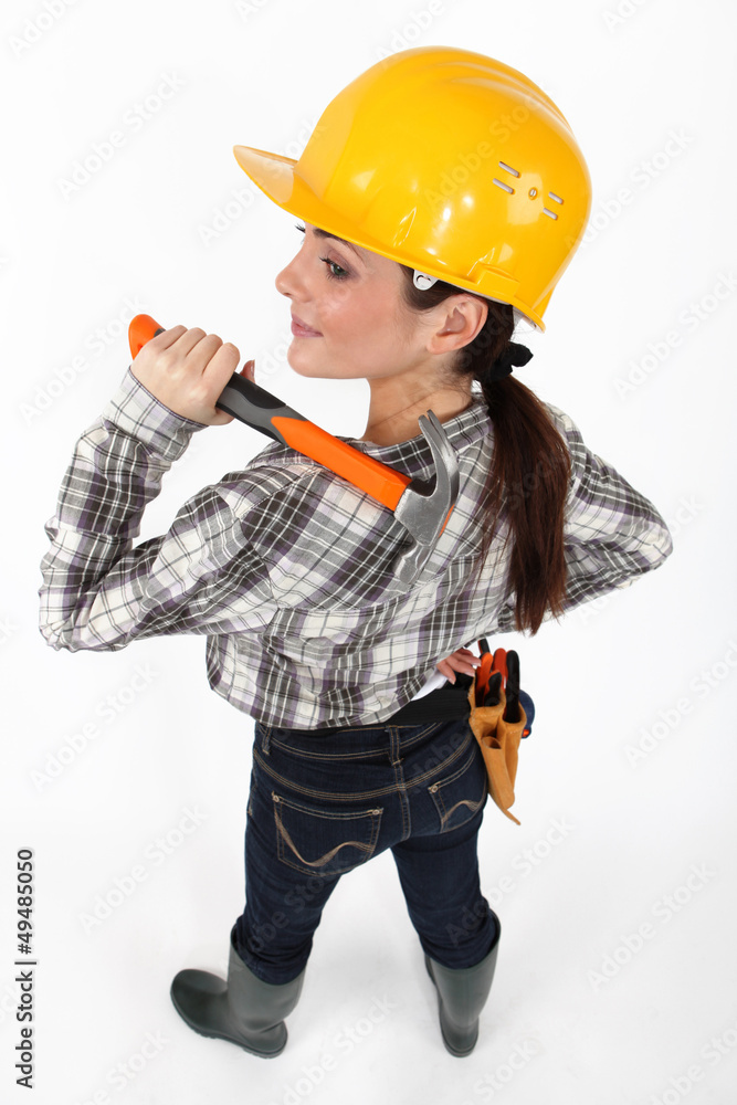 Woman resting hammer over shoulder Woman resting hammer over shoulder