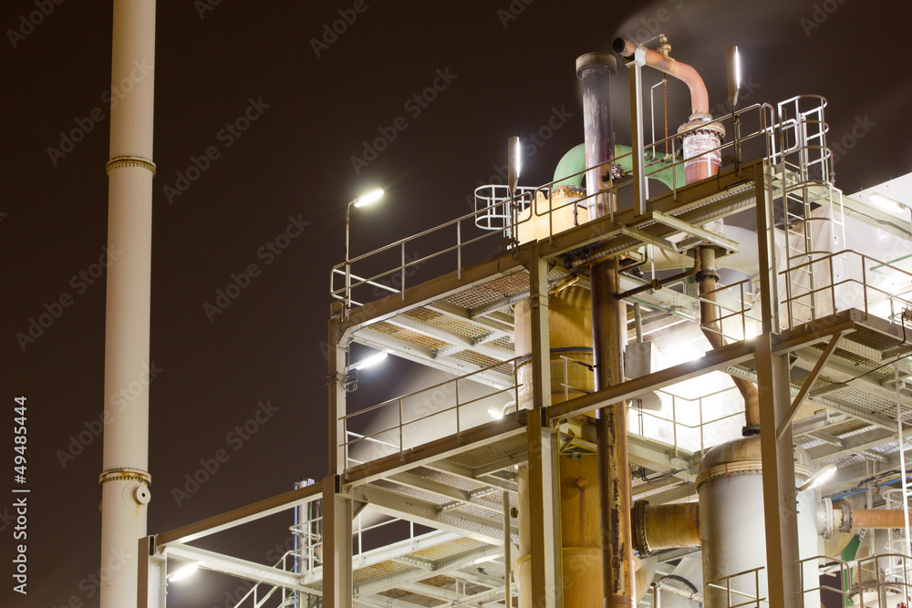 Close-up of industrial pipelines of an oil-refinery plant Close-up of industrial pipelines of an oil-refinery plant