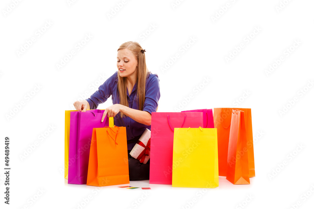 woman sitting on the floor behind shopping bags woman sitting on the floor behind shopping bags