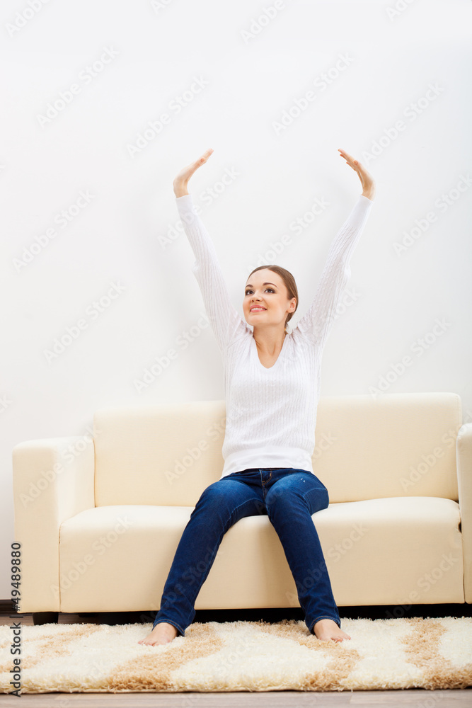 happy woman sitting on sofa happy woman sitting on sofa