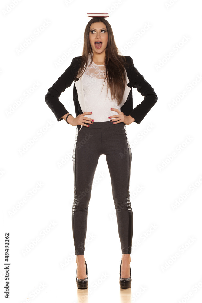attractive tall girl with a book on her head on white background attractive tall girl with a book on her head on white background