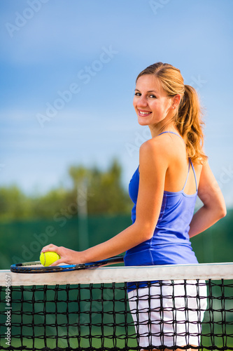 Portrait of a pretty young tennis player with copyspace © lightpoet