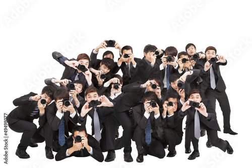 many photographers holding camera pointing to you